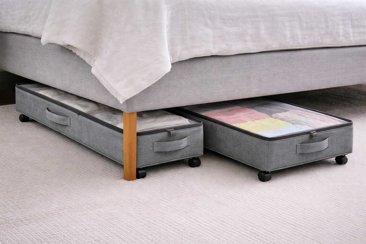 Under-bed storage containers with front handles and lids designed for easy sliding access